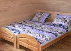 Dwa łóżka z fioletowa pościelą